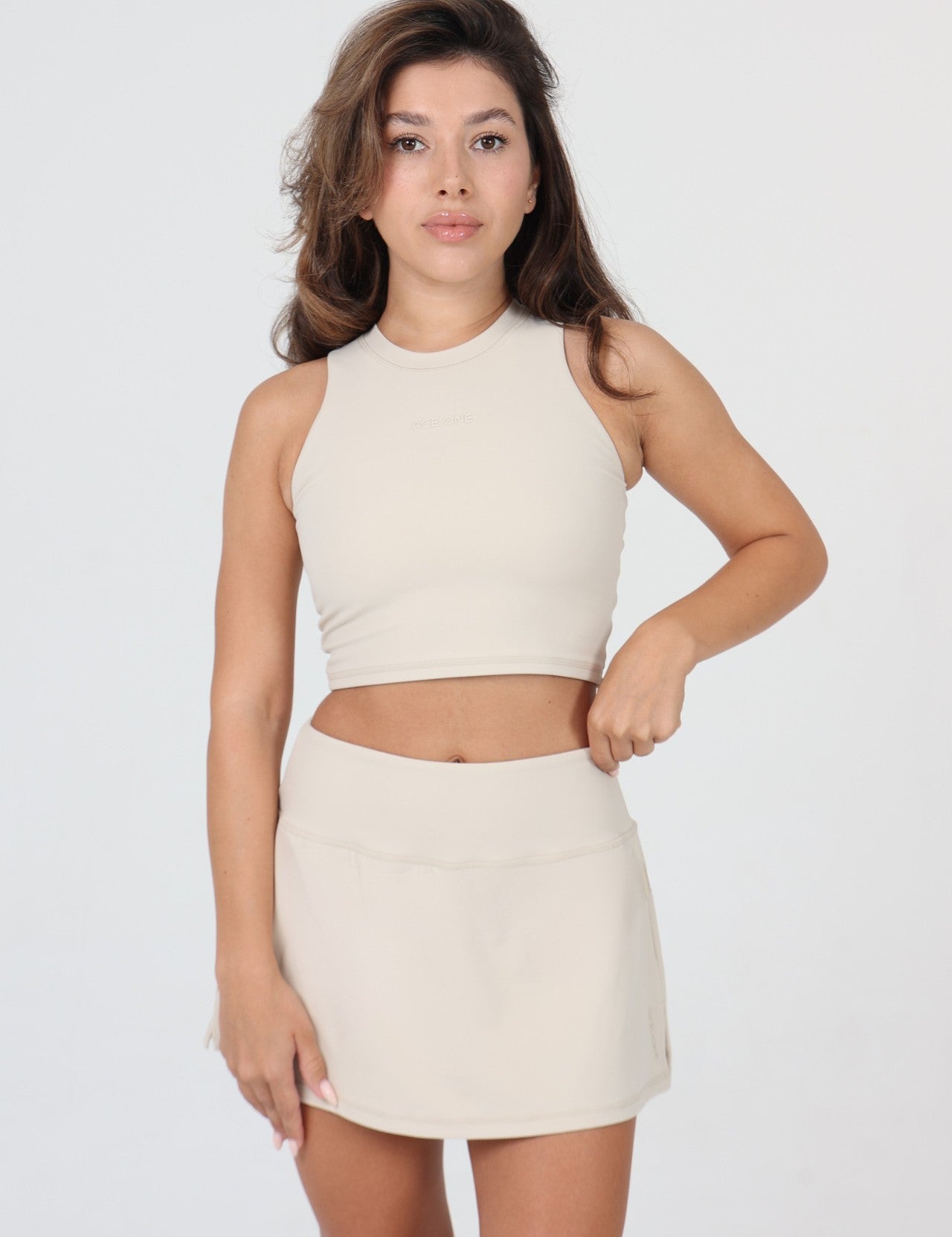 Ace One Beige high-neck women's tank top and skirt with build-in mini short for padel, tennis or everyday activewear.