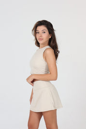 Ace One Beige high-neck women's tank top and skort fitted and breathable sportswear for padel, fitness, or everyday activewear.