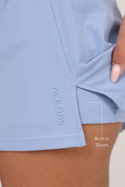 Ace One Women's blue active skort – lightweight sports skirt with built-in shorts, ideal for padel and tennis.