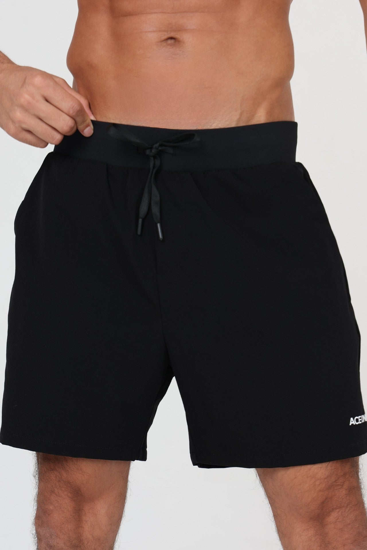 Man wearing ACE ONE black padel short on court